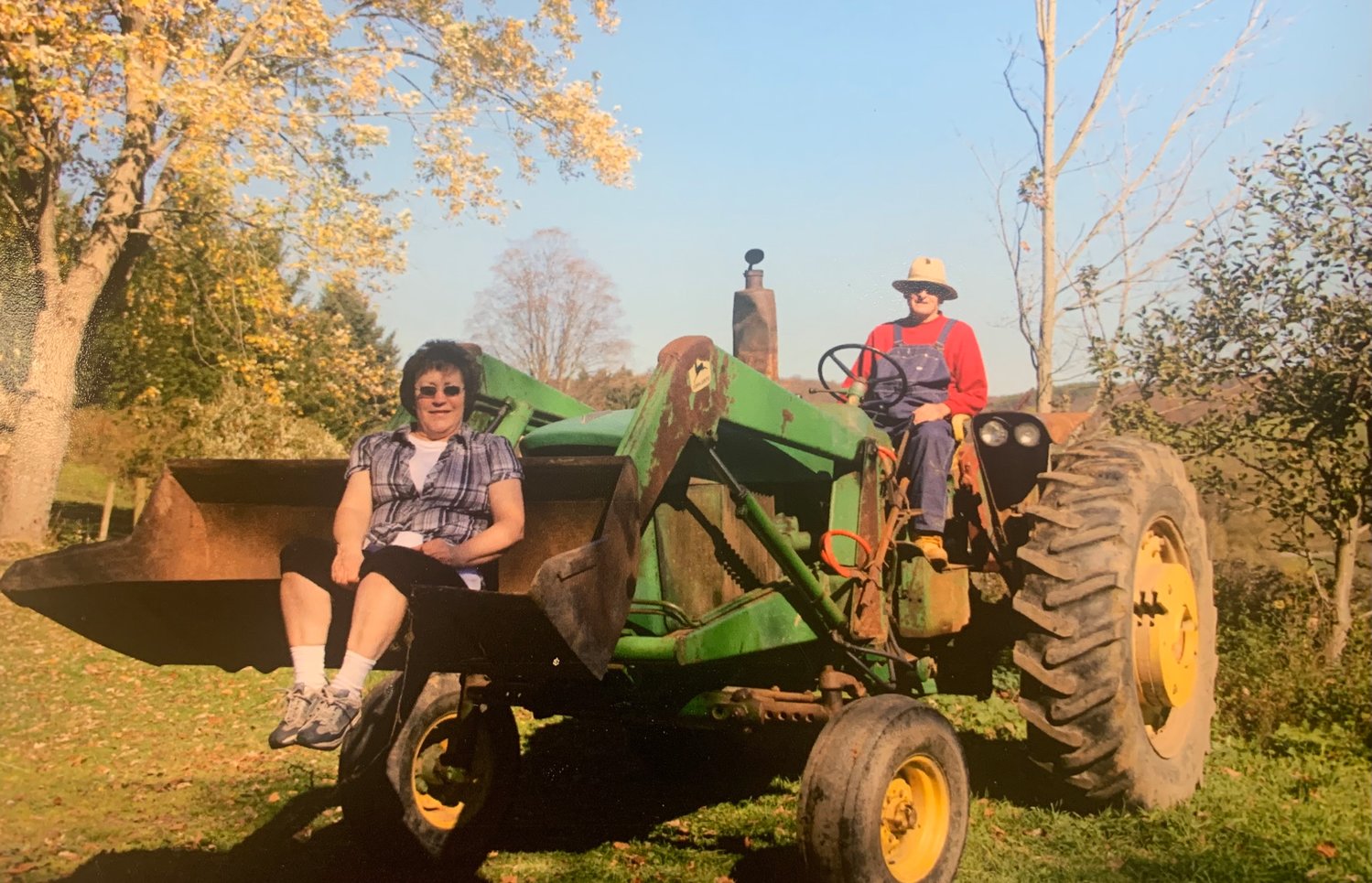 Dick and Jan Ewain with one of their John Deere tractors.